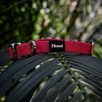 Pink dog collar with 'Zhani' brand name on a dark green leaf