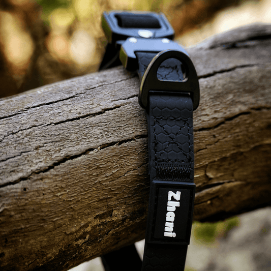 Black dog collar with brand name on a wooden log